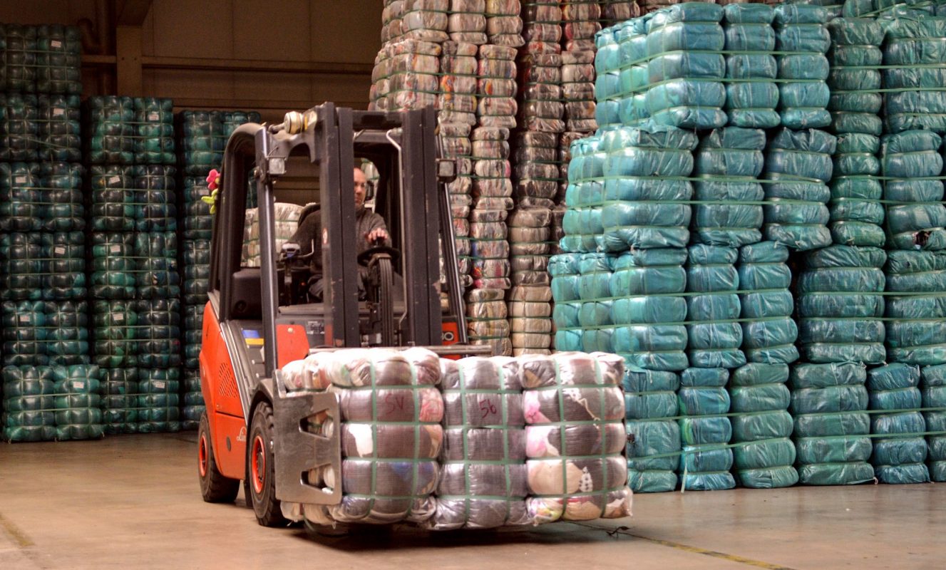 Apolda, Germany – June 3, 2014, A fork lift transports donated clothes at a German charity shop.