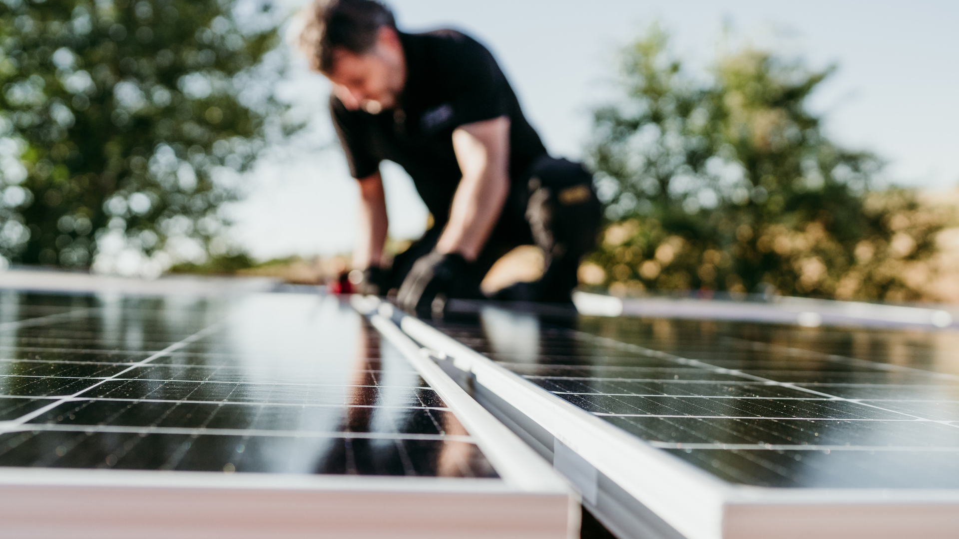 Eine Person verbaut PV-Zellen auf einer Fläche.